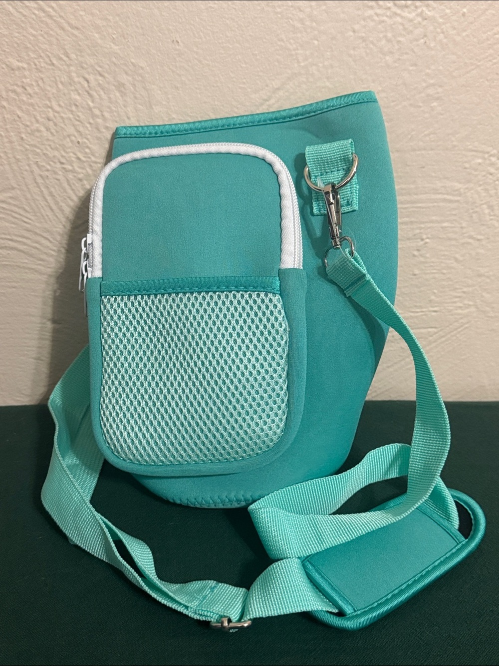 Teal Crossbody Sling Bag with Front Pocket for Water bottle.
